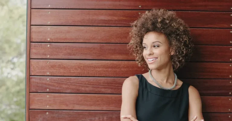 Confident woman after using cognitive reframing techniques to overcome CFA exam procrastination.