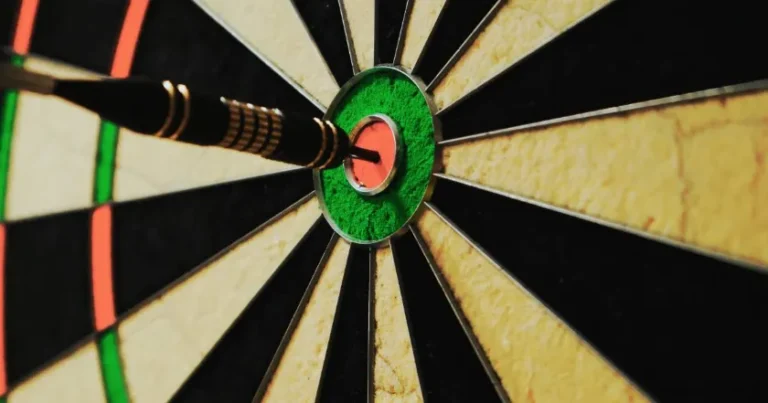 Bullseye Dartboard with Dart in the Center Representing Focus and Optimization in CFA Exam Preparation