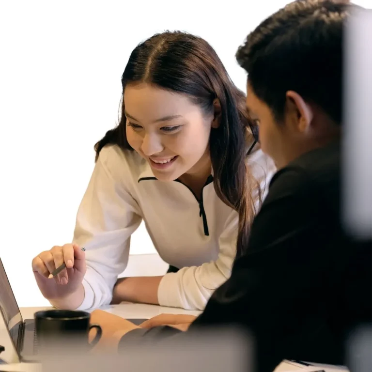 Two CFA Level 1 candidates studying on laptop