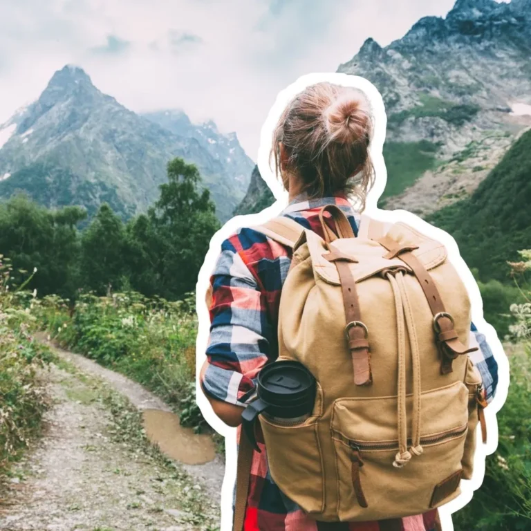 Person with backpack hiking along a mountain trail, symbolizing the transformative journey of completing CFA exams