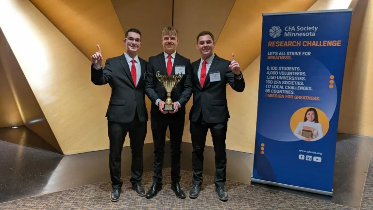 UWRF CFA Research Challenge team holding trophy after winning local finals in Minnesota