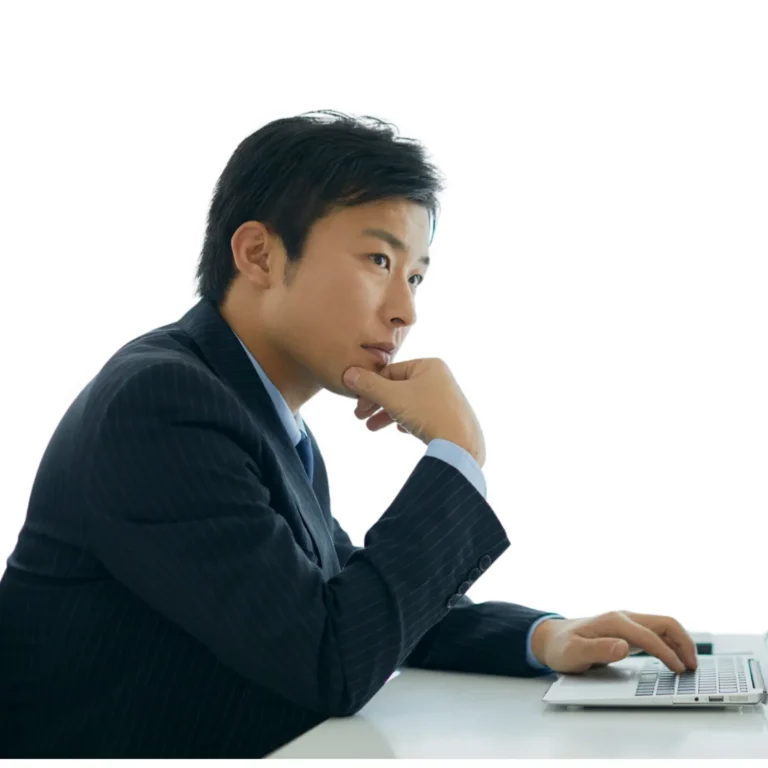 CFA candidate journaling and smiling in casual seated pose