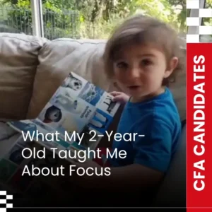 Toddler pointing at animal book while learning on couch